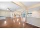 Spacious living area featuring hardwood floors, stone fireplace, and open flow to the modern kitchen at 5604 Stratford Ln, Lakeland, FL 33813