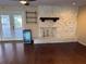 Inviting living room featuring a white stone fireplace, wooden shelving, and sliding doors at 5604 Stratford Ln, Lakeland, FL 33813