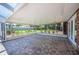 Covered patio area with brick pavers, providing a relaxing outdoor space with views of the backyard at 5604 Stratford Ln, Lakeland, FL 33813