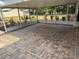 Enclosed patio featuring brick flooring and an enclosed view of the landscaped backyard area at 5604 Stratford Ln, Lakeland, FL 33813