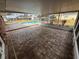 Enclosed patio featuring brick flooring with views of the pool and manicured backyard at 5604 Stratford Ln, Lakeland, FL 33813