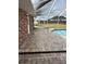 Pool deck showing brick flooring with outdoor access and view of backyard area at 5604 Stratford Ln, Lakeland, FL 33813
