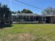 Backyard pool with a screened-in enclosure and a grass border at 5604 Stratford Ln, Lakeland, FL 33813