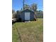 Backyard storage shed with wood lap siding and access ramp in a spacious yard at 5604 Stratford Ln, Lakeland, FL 33813