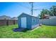 Backyard with a light blue tool shed with a white door and steps at 5604 Stratford Ln, Lakeland, FL 33813