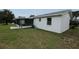 A bright back exterior with a screened in patio and a large yard at 6131 Doe E Cir, Lakeland, FL 33809
