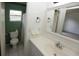 Bathroom featuring a toilet, shower with curtain, vanity, and tile floors and walls at 6131 Doe E Cir, Lakeland, FL 33809