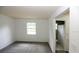 Neutral bedroom featuring carpeted floors and an adjoining bathroom with natural lighting at 6131 Doe E Cir, Lakeland, FL 33809