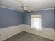Cozy bedroom with blue walls, white trim, carpeted floors, and natural lighting at 6131 Doe E Cir, Lakeland, FL 33809