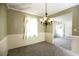 Cozy dining room featuring plush carpeting, classic chandelier, and natural light at 6131 Doe E Cir, Lakeland, FL 33809