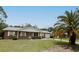 Well-kept brick home with a spacious front yard, mature landscaping, and attached garage at 6131 Doe E Cir, Lakeland, FL 33809