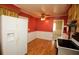 Eat-in kitchen featuring hardwood floors, white refrigerator, ceiling fan, and neutral wall and trim colors at 6131 Doe E Cir, Lakeland, FL 33809
