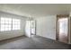 Inviting living room featuring plush carpeting, natural light, and a welcoming atmosphere at 6131 Doe E Cir, Lakeland, FL 33809