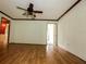 Spacious living room featuring hardwood floors, a ceiling fan, and abundant natural light at 6131 Doe E Cir, Lakeland, FL 33809