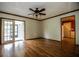Spacious living room featuring hardwood floors, a ceiling fan, and abundant natural light at 6131 Doe E Cir, Lakeland, FL 33809