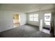 Bright living room featuring plush carpeting, natural light, and open layout at 6131 Doe E Cir, Lakeland, FL 33809