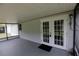 A view of the screened in patio with double doors leading to the backyard at 6131 Doe E Cir, Lakeland, FL 33809