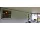 This covered patio has double doors leading inside and screens to keep pests out at 6131 Doe E Cir, Lakeland, FL 33809