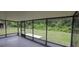 This home features a large screened in patio with views of the backyard and surrounding foliage at 6131 Doe E Cir, Lakeland, FL 33809