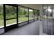 Relaxing screened porch with concrete floors and a view of the spacious backyard at 6131 Doe E Cir, Lakeland, FL 33809