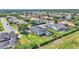 Spacious backyard with screened pool, playground, and green lawn surrounded by a neighborhood at 6546 Eagle View Loop, Lakeland, FL 33813