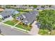 Aerial view of a home with lush landscaping, a three-car garage, and mature trees at 6546 Eagle View Loop, Lakeland, FL 33813