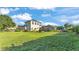 The spacious backyard includes lush green grass, mature landscaping, a playground, and a cozy fire pit area at 6546 Eagle View Loop, Lakeland, FL 33813