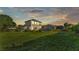 Large backyard with a spacious lawn, mature trees, and an outdoor entertainment area with playground at 6546 Eagle View Loop, Lakeland, FL 33813