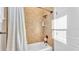 Well lit bathroom showcasing a tub and shower combination with tile surround and white shower curtain at 6546 Eagle View Loop, Lakeland, FL 33813