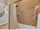 Neutral bathroom with a shower-tub combo featuring tile surround and bronze fixtures at 6546 Eagle View Loop, Lakeland, FL 33813