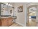 Bathroom featuring granite counters, a vanity with a stool, a decorative mirror, and ensuite access at 6546 Eagle View Loop, Lakeland, FL 33813