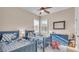 Bright bedroom featuring two twin beds with matching blue bedding, ceiling fan and ample natural light at 6546 Eagle View Loop, Lakeland, FL 33813