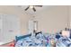 Bedroom showcasing two twin beds with ceiling fan, closet and view into another room at 6546 Eagle View Loop, Lakeland, FL 33813