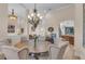Elegant dining room features a large round table, stylish chairs, and a decorative chandelier at 6546 Eagle View Loop, Lakeland, FL 33813