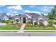 This aerial view features lush landscaping surrounding a well-manicured lawn and stone paver walkway at 6546 Eagle View Loop, Lakeland, FL 33813