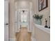 Hallway featuring wood floors, neutral walls, white trim, and a view into the bathroom at 6546 Eagle View Loop, Lakeland, FL 33813