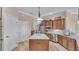 Well-equipped kitchen with stainless appliances, center island with a white countertop, and dark cabinets at 6546 Eagle View Loop, Lakeland, FL 33813