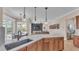 Beautiful open concept with kitchen island, sink, and adjacent living room and dinette at 6546 Eagle View Loop, Lakeland, FL 33813