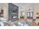 Stylish living room with a modern fireplace, elegant furniture, and an open floor plan to the dining area at 6546 Eagle View Loop, Lakeland, FL 33813