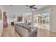 Open-concept living space with a sectional sofa, sliding glass doors, and views of the outdoor patio at 6546 Eagle View Loop, Lakeland, FL 33813