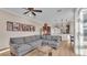 Cozy living room featuring a sectional sofa, round wood table, and a gallery wall of Gathering photos at 6546 Eagle View Loop, Lakeland, FL 33813