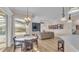 Open floor plan featuring a dining area, a spacious living room, and access to the backyard pool at 6546 Eagle View Loop, Lakeland, FL 33813