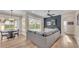 Bright living room with modern decor, hardwood floors, and a view of the outdoor pool area at 6546 Eagle View Loop, Lakeland, FL 33813