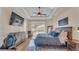 Spacious main bedroom with tray ceiling, ensuite bathroom access, and sliding glass doors to the pool at 6546 Eagle View Loop, Lakeland, FL 33813