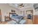 Comfortable main bedroom with a large bed, ensuite access, a decorative rug, and a modern design at 6546 Eagle View Loop, Lakeland, FL 33813