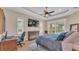 Bright main bedroom with a tray ceiling, ensuite access, and a view of the pool area from sliding doors at 6546 Eagle View Loop, Lakeland, FL 33813