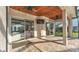 A covered patio features ceiling fans, a mounted television, and access to the pool through sliding glass doors at 6546 Eagle View Loop, Lakeland, FL 33813
