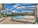 Screened-in pool featuring a brick patio and clear blue water, perfect for relaxation and outdoor enjoyment at 6546 Eagle View Loop, Lakeland, FL 33813