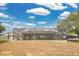 Large backyard featuring a screened-in pool enclosure and a spacious grassy area at 6750 Lemon Tree Dr, Lakeland, FL 33813