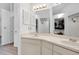 Bathroom featuring double sinks with a large mirror and doors to closets at 6750 Lemon Tree Dr, Lakeland, FL 33813
